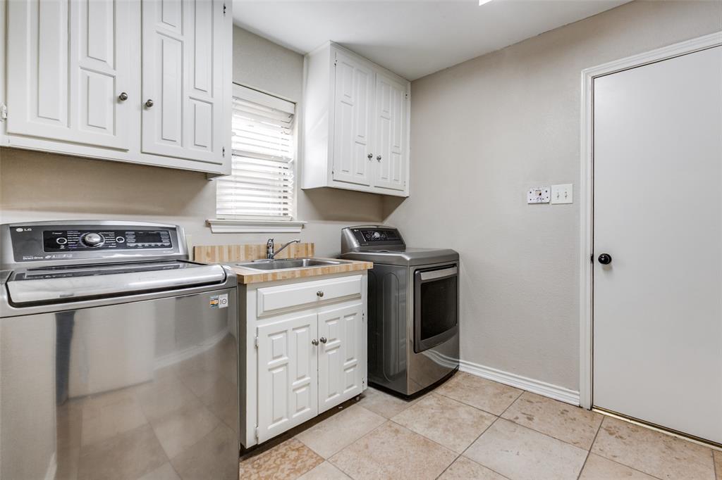 15881 Nedra Way Dallas, TX 75248 - Photo 22 of 26 a kitchen with cabinets appliances and a window