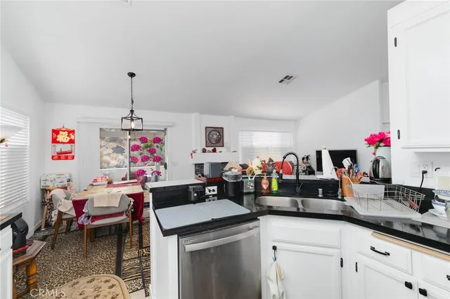 a kitchen that has a lot of cabinets a sink and a stove