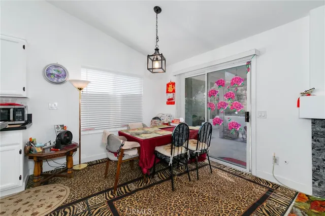 a dining room with furniture and window