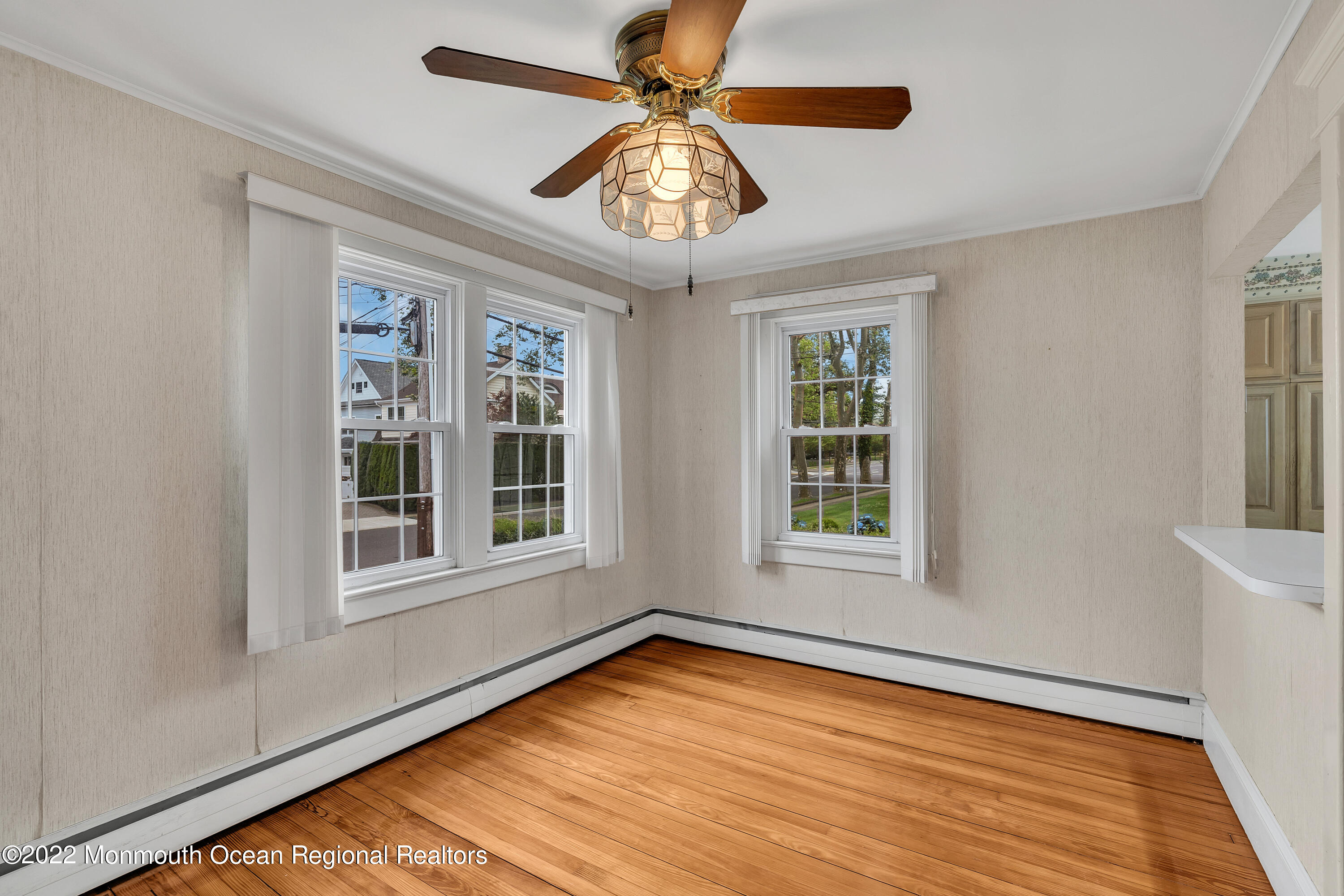1107 5th Avenue Spring Lake, NJ 07762 - Photo 15 of 30 a view of an empty room with a window and wooden floor