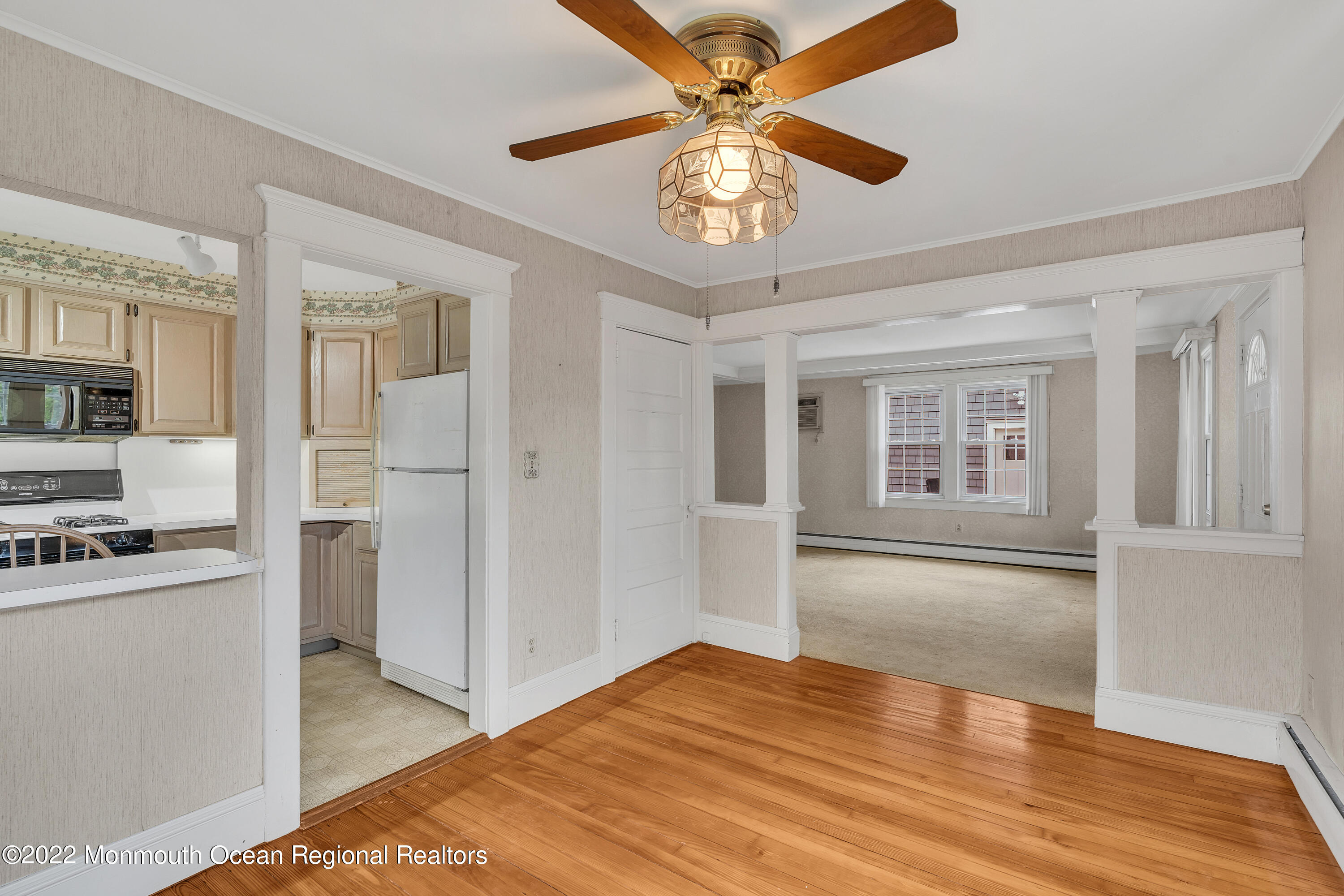 1107 5th Avenue Spring Lake, NJ 07762 - Photo 16 of 30 a view of a kitchen with a stove cabinets a ceiling fan and wooden floor