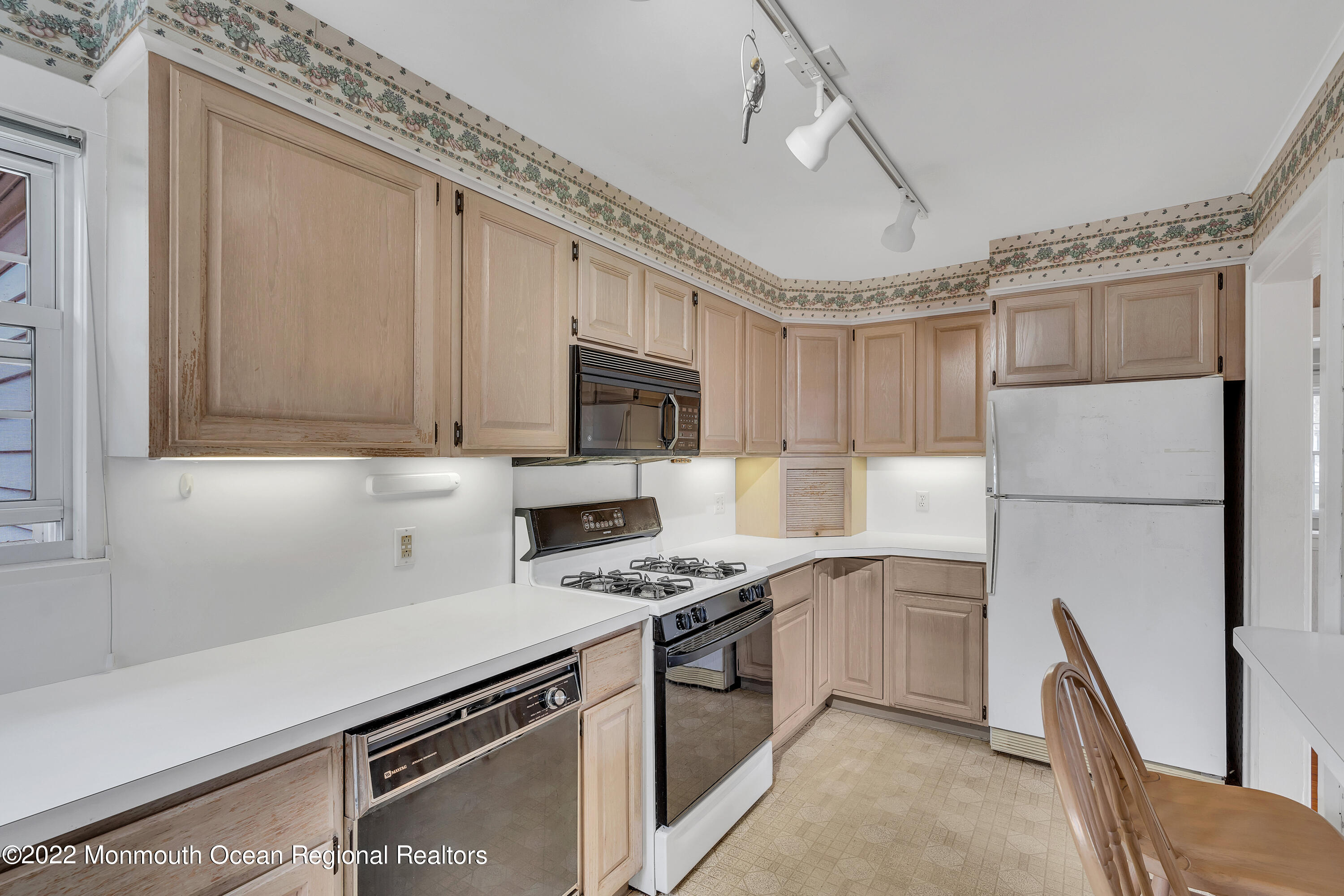1107 5th Avenue Spring Lake, NJ 07762 - Photo 18 of 30 a kitchen with stainless steel appliances granite countertop a sink a stove a refrigerator cabinets and a dining table