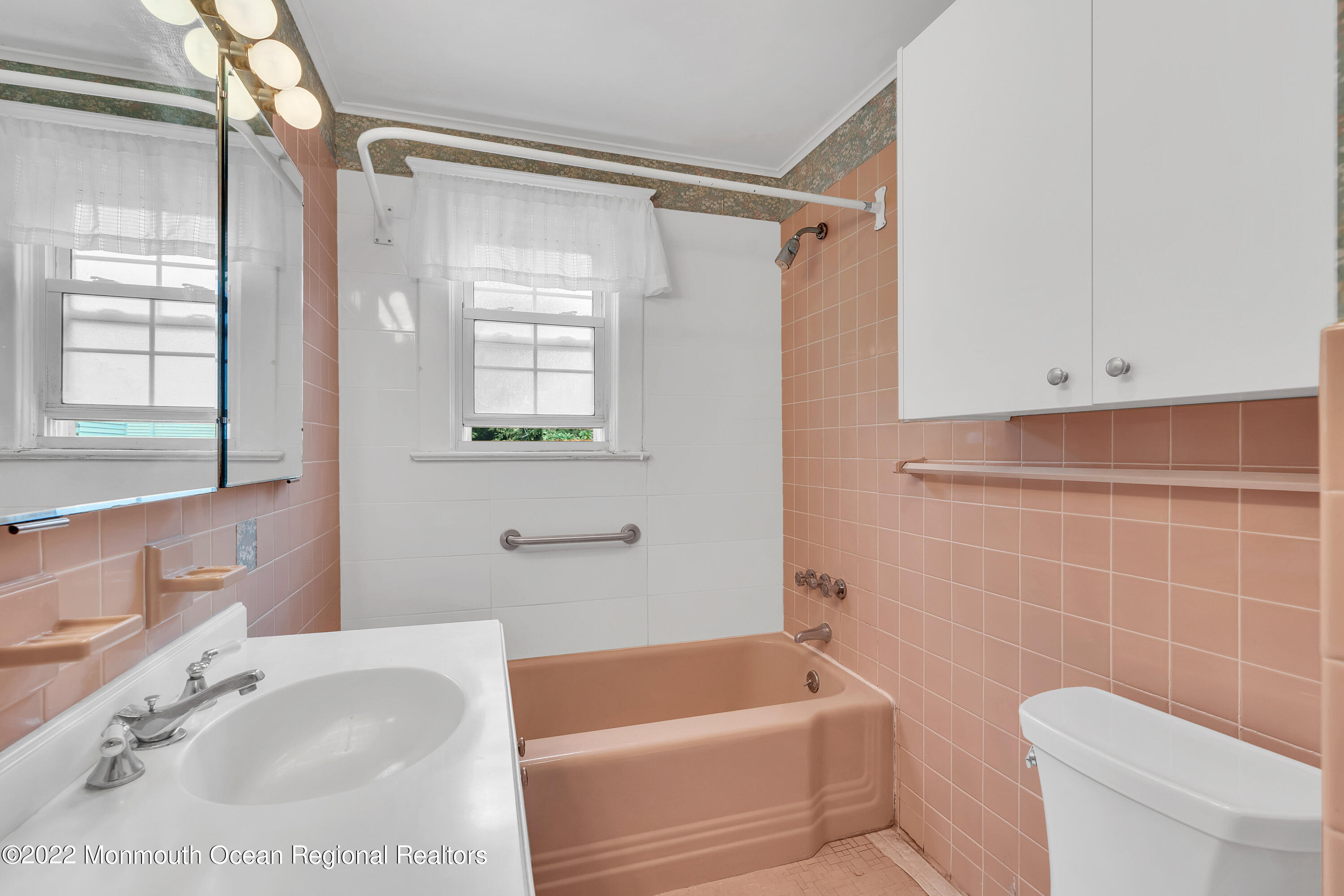 1107 5th Avenue Spring Lake, NJ 07762 - Photo 24 of 30 a bathroom with a tub a toilet and a sink