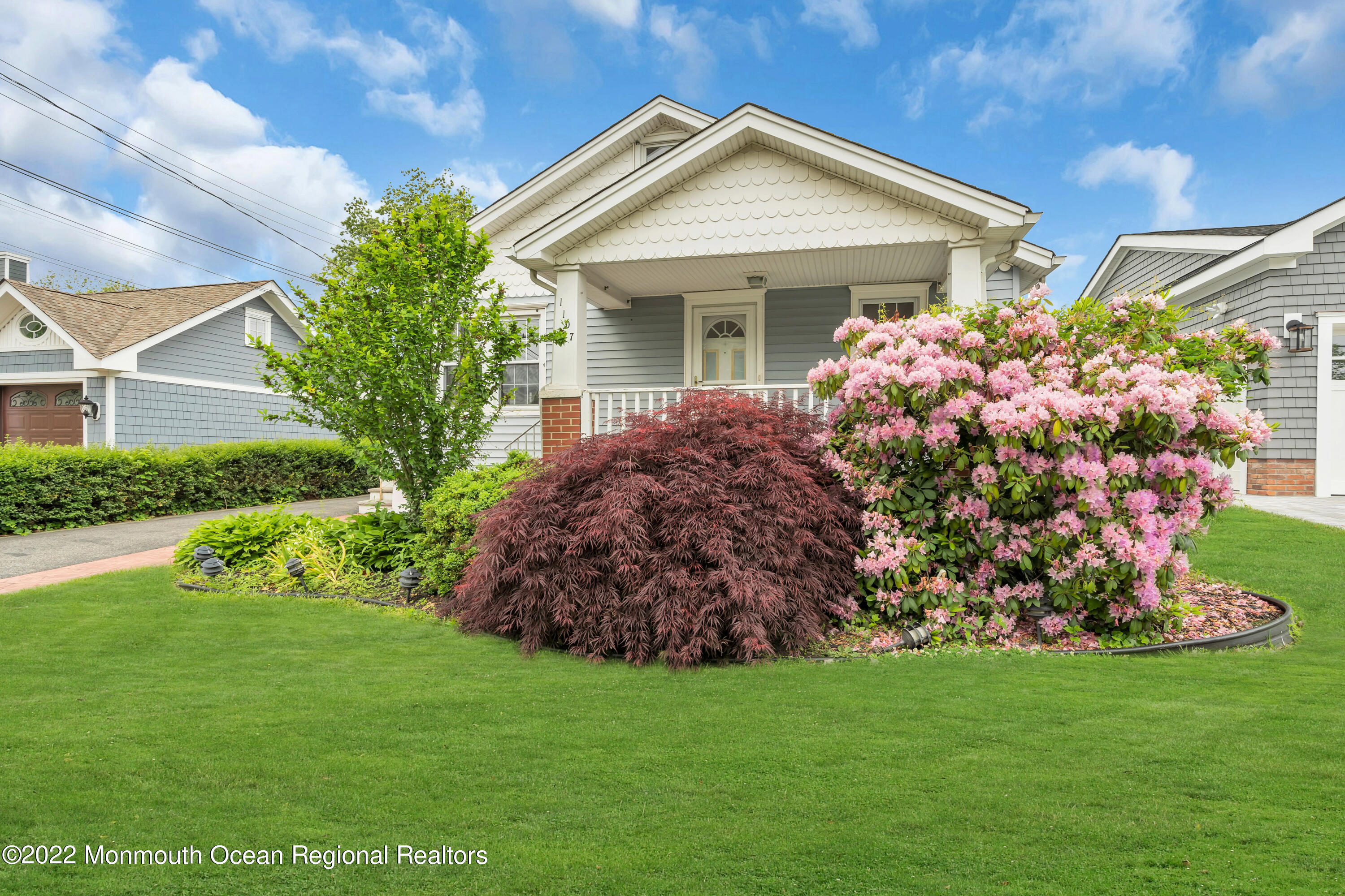 1107 5th Avenue Spring Lake, NJ 07762 - Photo 3 of 30 a front view of a house with a garden
