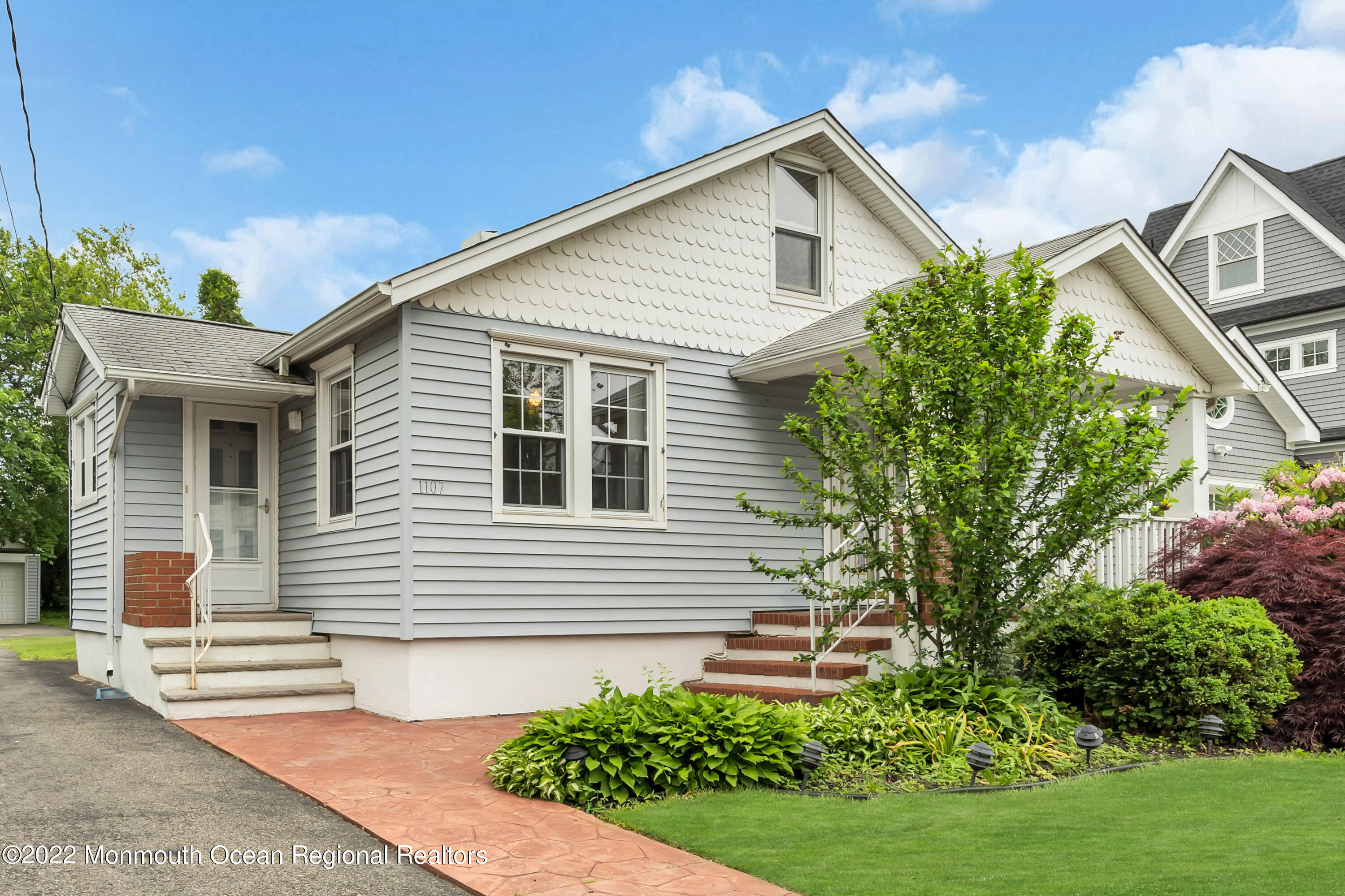 1107 5th Avenue Spring Lake, NJ 07762 - Photo 5 of 30 a front view of a house with a yard