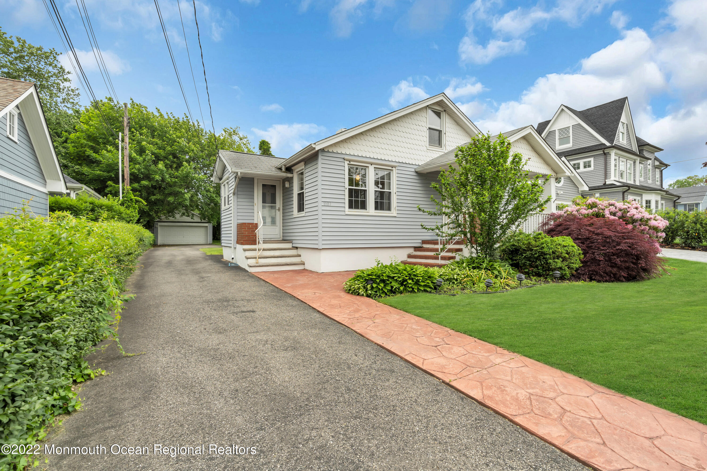 1107 5th Avenue Spring Lake, NJ 07762 - Photo 6 of 30 a front view of a house with a yard and potted plants