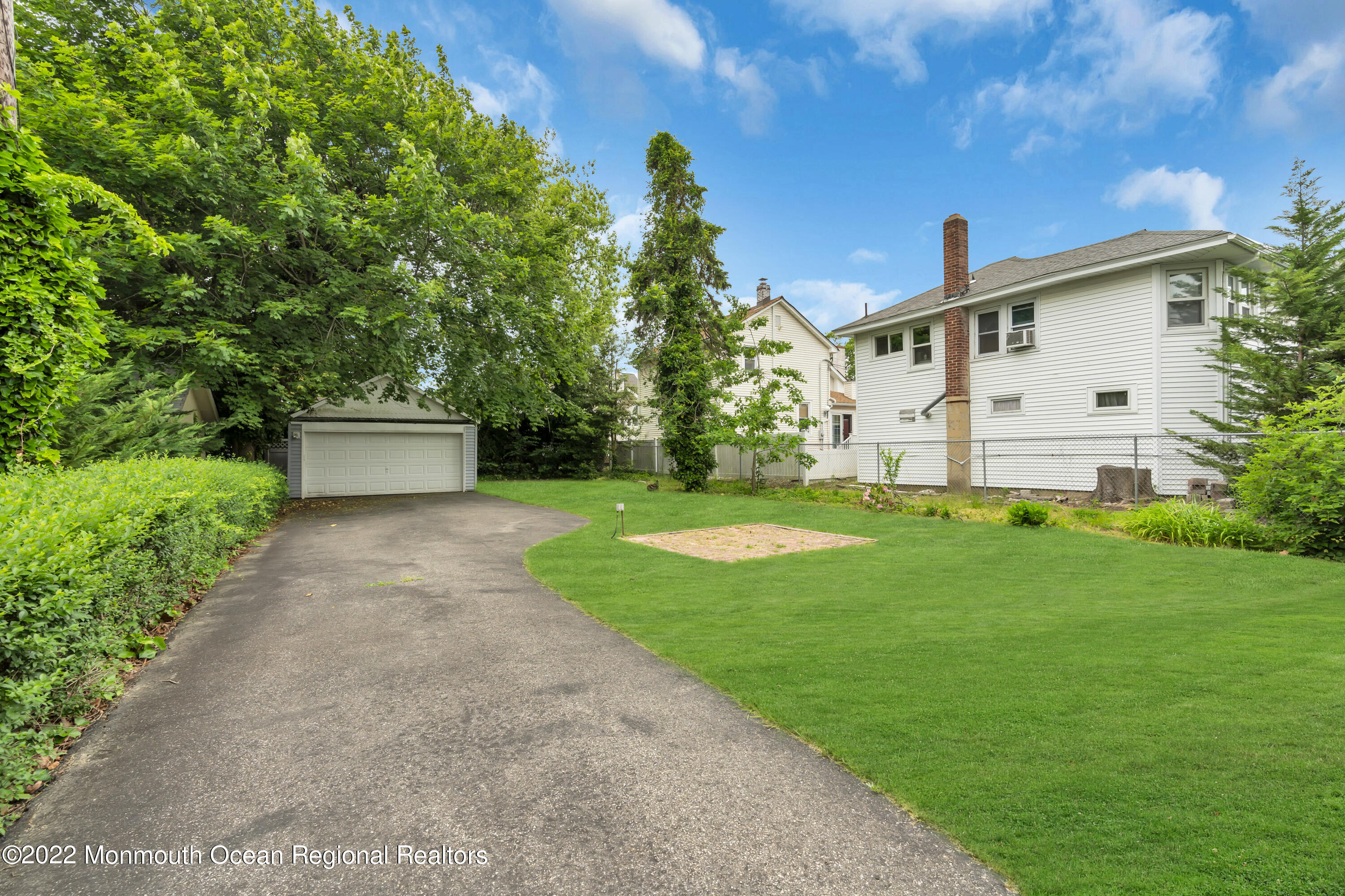 1107 5th Avenue Spring Lake, NJ 07762 - Photo 7 of 30 a front view of a house with a yard and trees