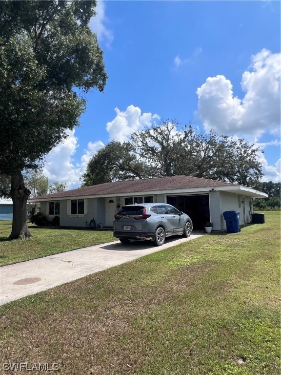 4020 Rainbow Circle LaBelle, FL 33935 - Photo 3 of 30 a view of house with yard and entertaining space