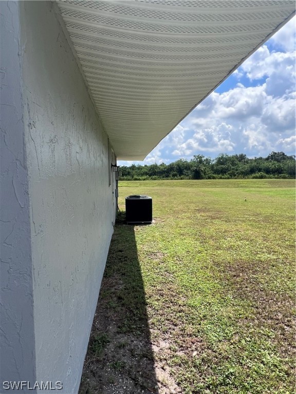 4020 Rainbow Circle LaBelle, FL 33935 - Photo 4 of 30 a swimming pool with outdoor seating and garden