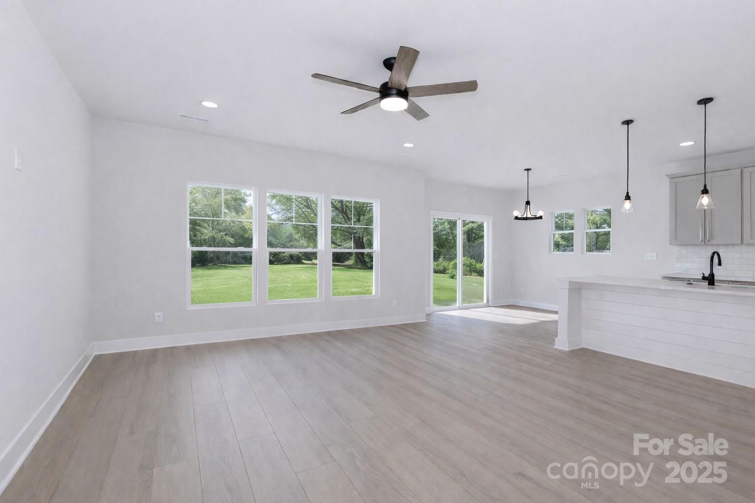 269 Monticello Road Statesville, NC 28625 - Photo 12 of 31 a view of an empty room with a window and wooden floor