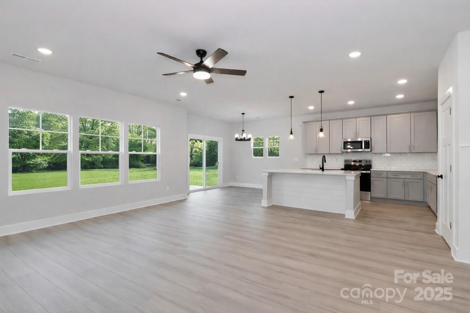 269 Monticello Road Statesville, NC 28625 - Photo 13 of 31 a view of kitchen with refrigerator stove and wooden floor