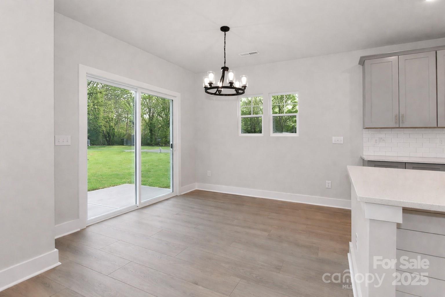 269 Monticello Road Statesville, NC 28625 - Photo 16 of 31 a view of an empty room with window wooden floor and windows