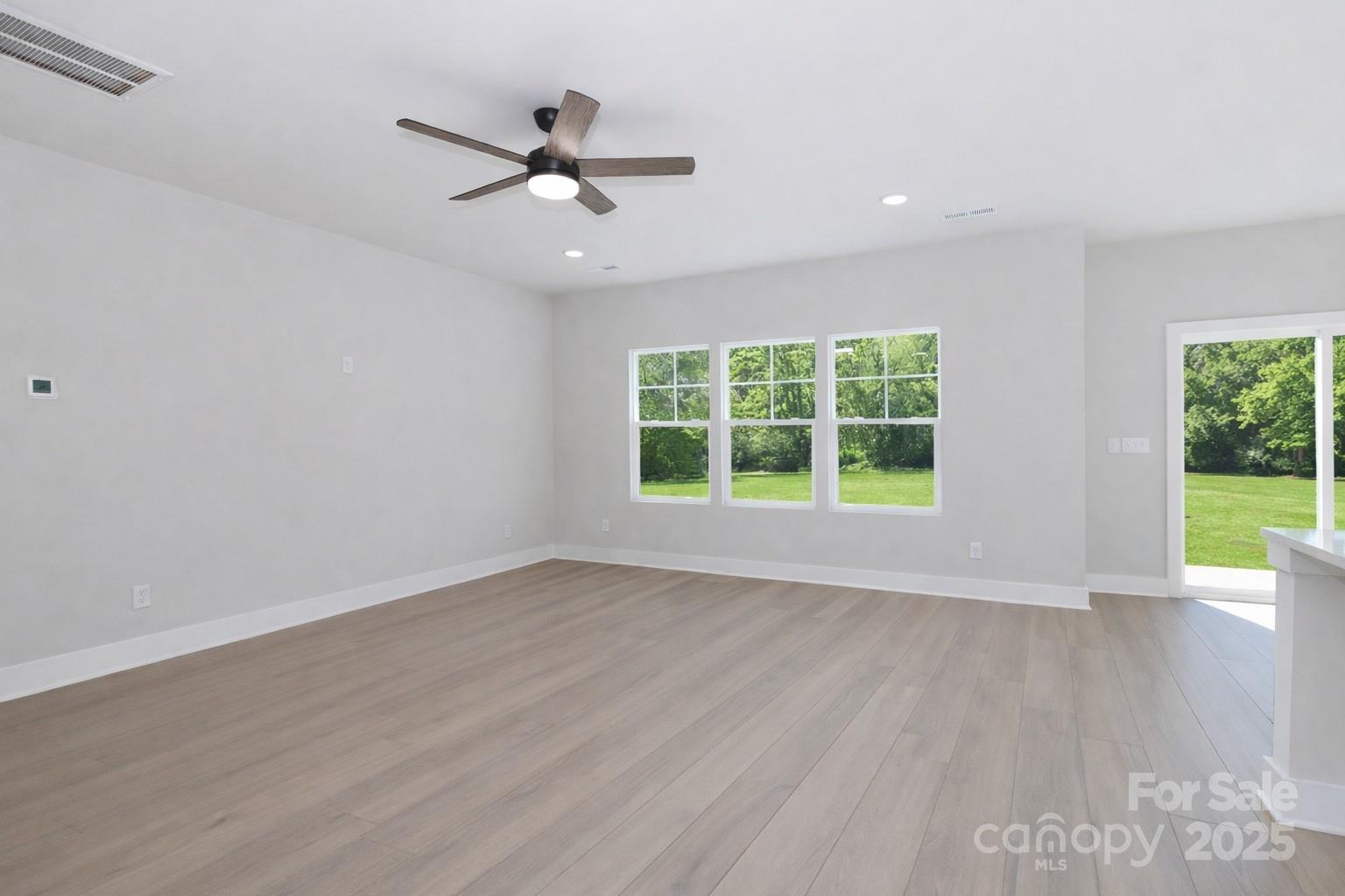 269 Monticello Road Statesville, NC 28625 - Photo 17 of 31 a view of an empty room with wooden floor and a window