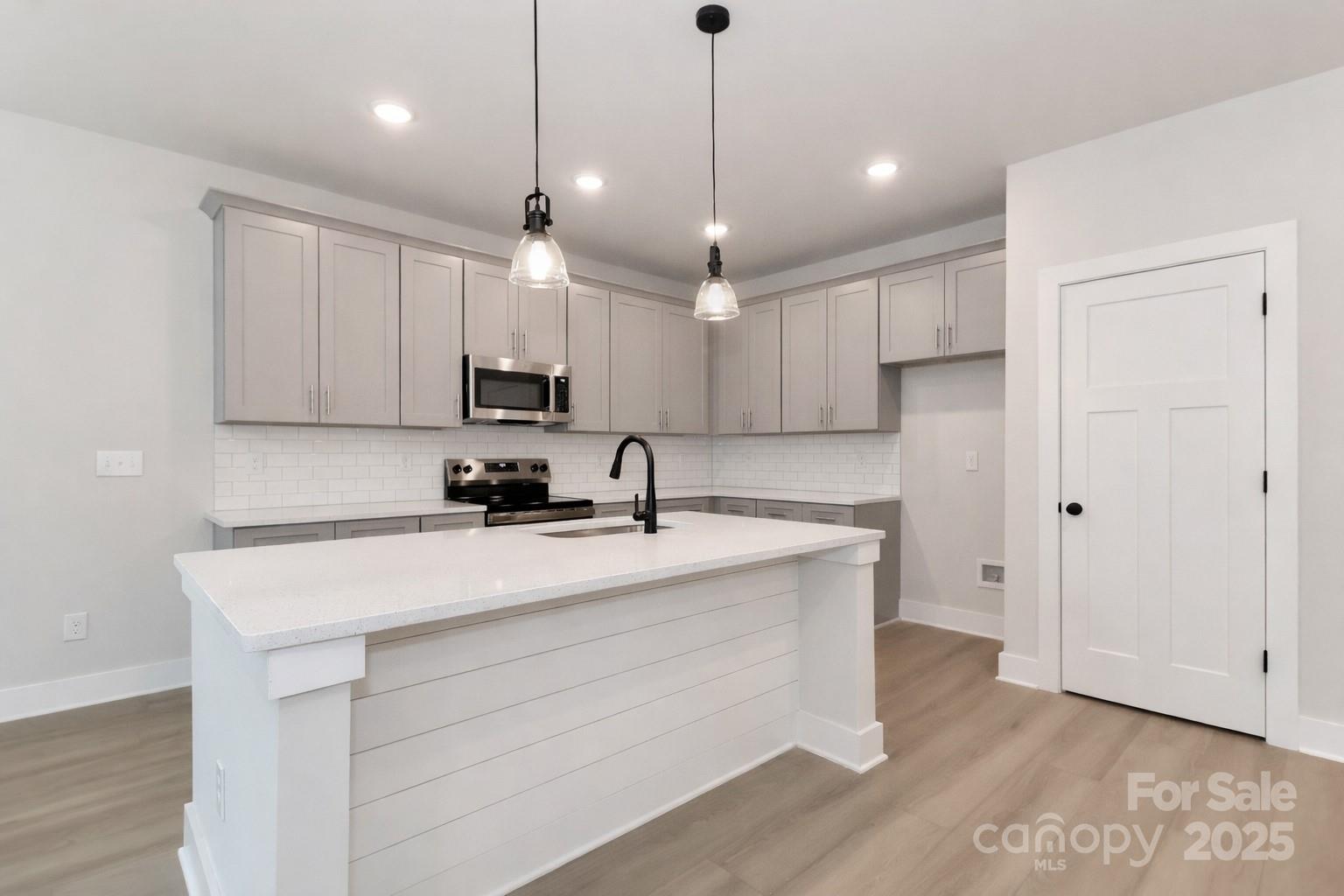 269 Monticello Road Statesville, NC 28625 - Photo 8 of 31 a kitchen with kitchen island a sink stainless steel appliances and cabinets