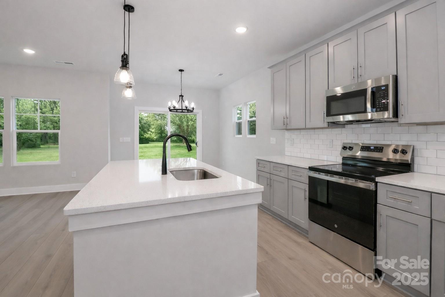 269 Monticello Road Statesville, NC 28625 - Photo 9 of 31 a kitchen with stainless steel appliances granite countertop a sink a stove a microwave a sink and a refrigerator