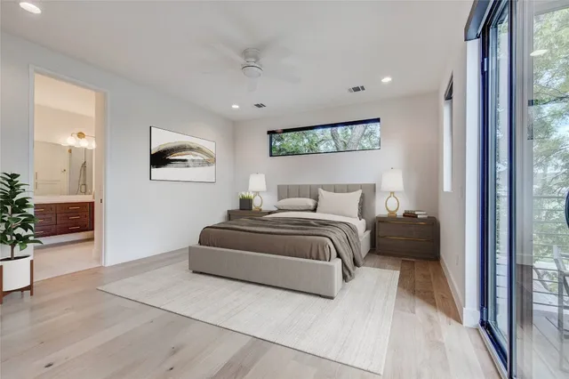 a bedroom with a bed and a painting on the wall