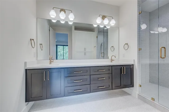a bathroom with a double vanity sink and a mirror