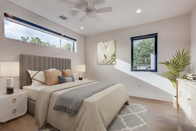 a bedroom with bed and a large window