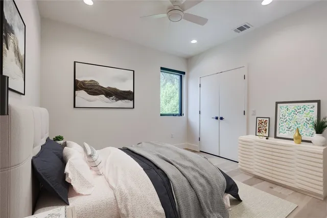 a bedroom with a bed and a painting on the wall