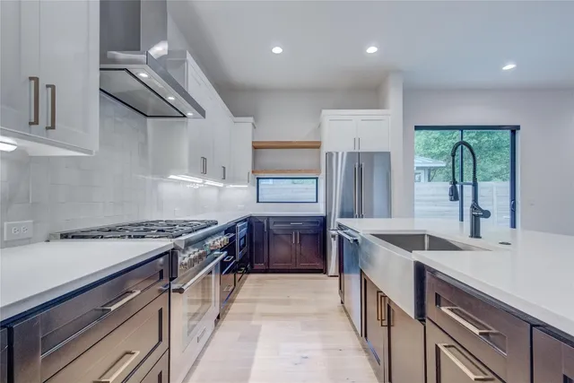 a kitchen with stainless steel appliances granite countertop a sink stove and cabinets
