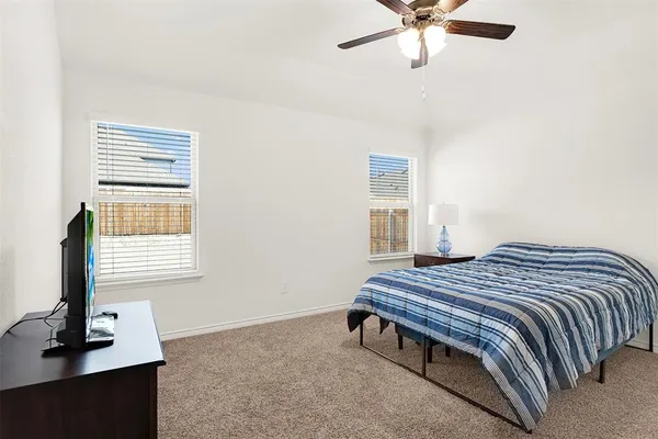 a bedroom with a bed table and window