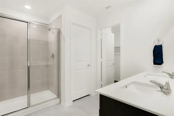 a bathroom with a shower sink and mirror