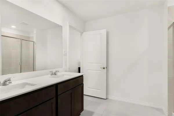 a bathroom with a double vanity sink and mirror