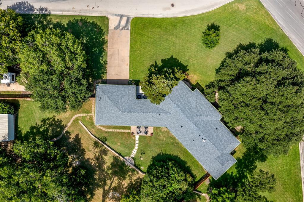 6700 Fortune Road Fort Worth, TX 76116 - Photo 38 of 40 Expansive property featuring a grey shingle roof, concrete driveway, and mature landscaping