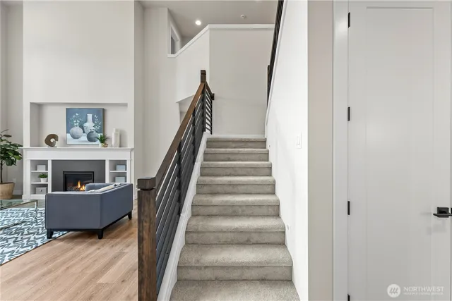 a view of entryway and hall with wooden floor
