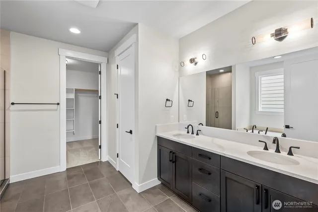 a spacious bathroom with a double vanity sink mirror and double
