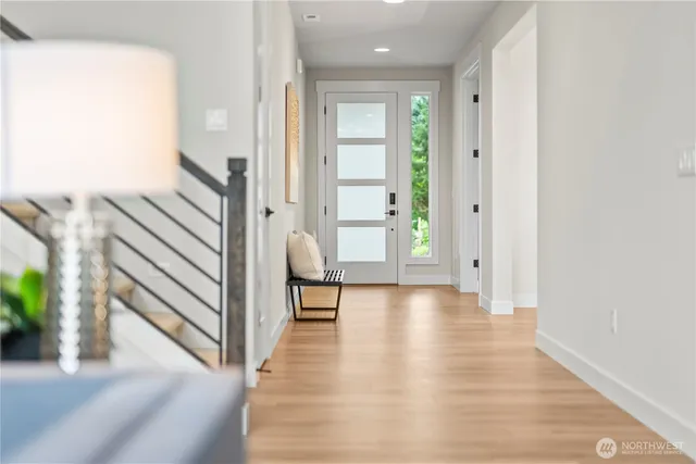 a view of a room with wooden floor and furniture