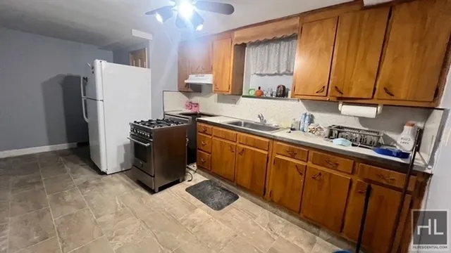 a kitchen with a refrigerator stove and sink
