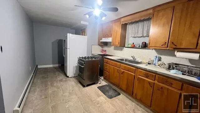 a kitchen with refrigerator a sink and cabinets