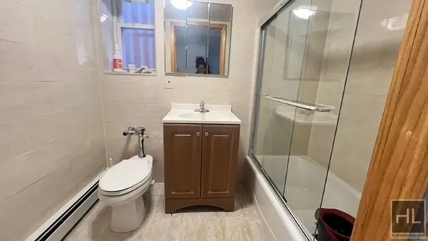 a bathroom with a toilet a sink and mirror