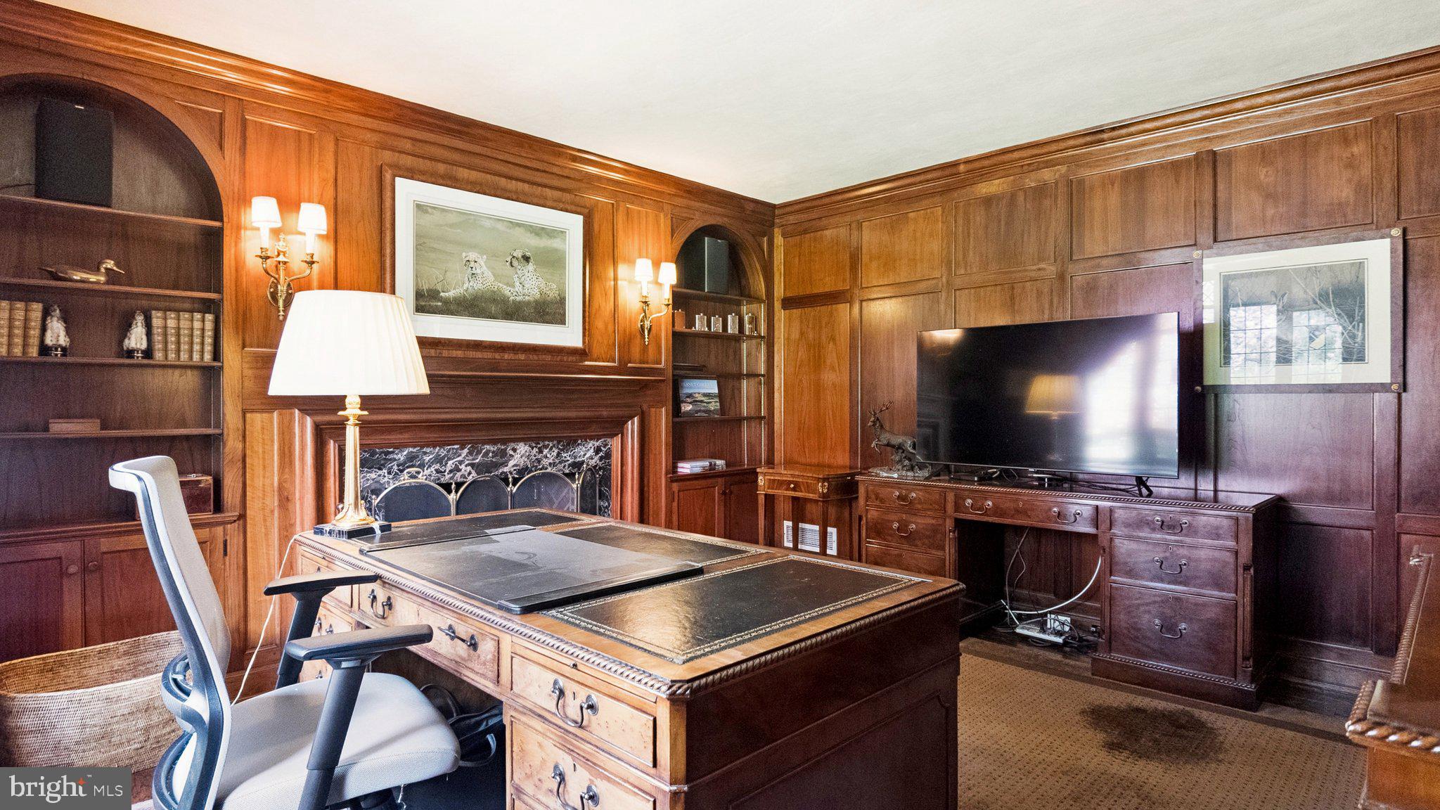 517 Fishers Road Bryn Mawr, PA 19010 - Photo 23 of 70 a living room with furniture a flat screen tv and a fireplace