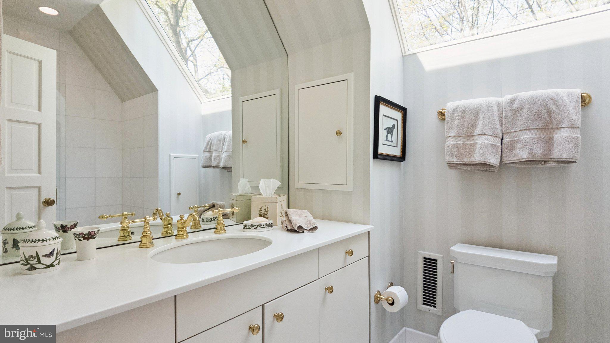 517 Fishers Road Bryn Mawr, PA 19010 - Photo 42 of 70 a bathroom with a toilet sink and mirror