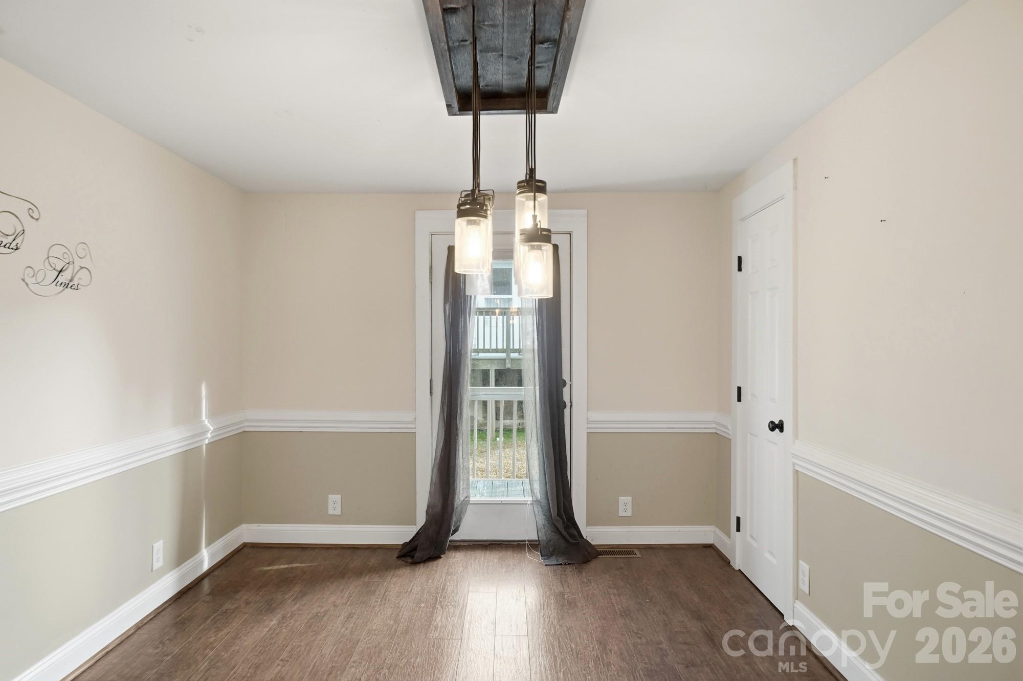 149 Swink Street Southwest Concord, NC 28027 - Photo 11 of 24 a view of entryway with a chandelier and wooden floor