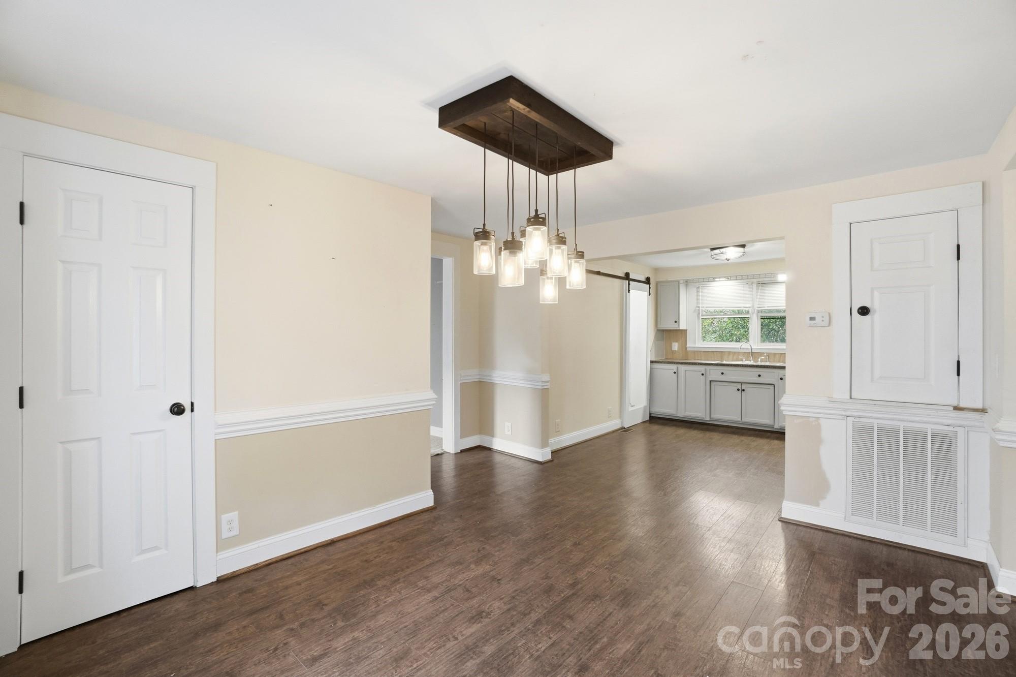 149 Swink Street Southwest Concord, NC 28027 - Photo 12 of 24 an empty room with wooden floor and windows