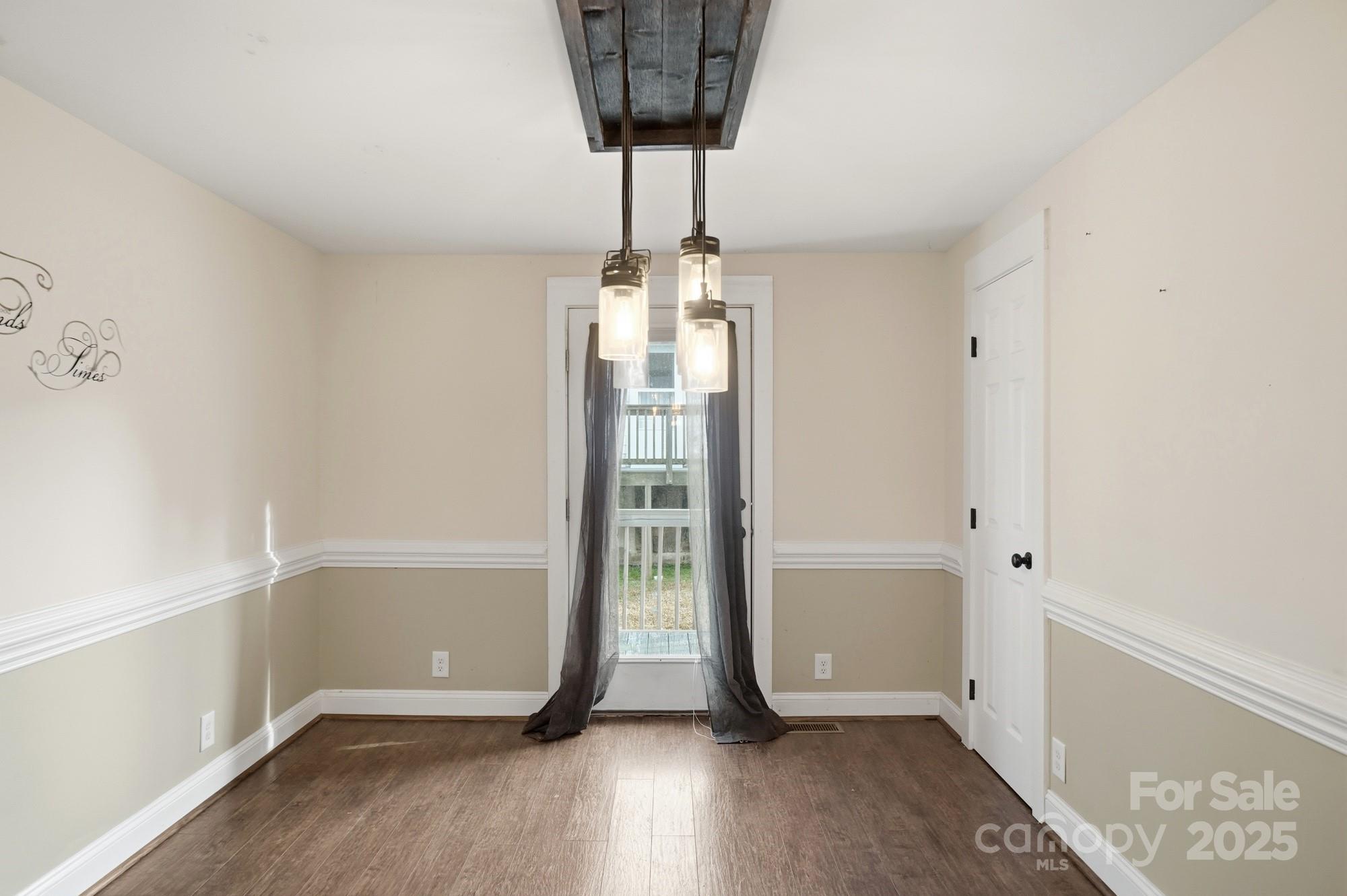 149 Swink Street Southwest Concord, NC 28027 - Photo 13 of 27 a view of entryway with a chandelier and wooden floor