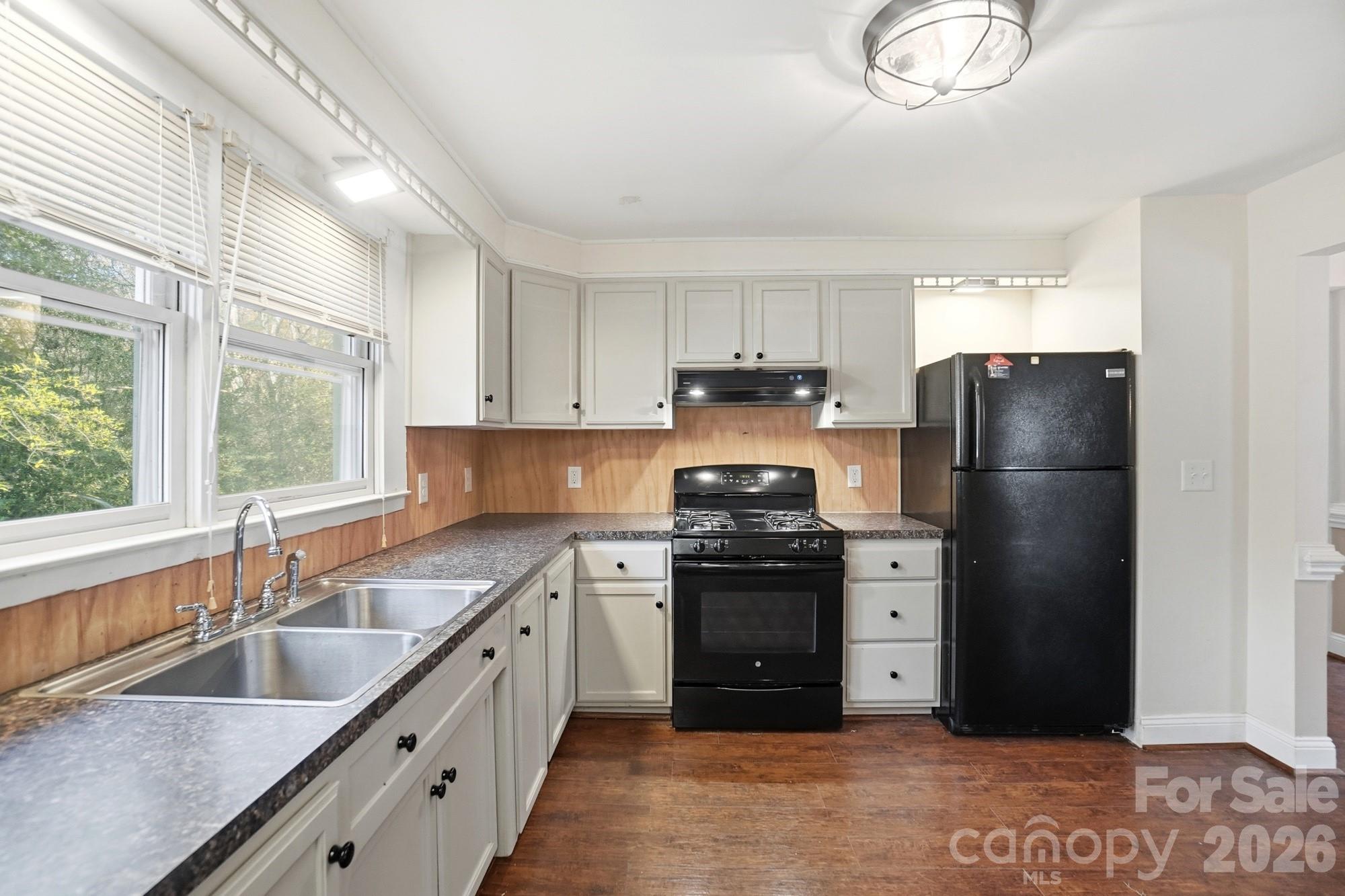 149 Swink Street Southwest Concord, NC 28027 - Photo 14 of 24 a kitchen with stainless steel appliances granite countertop a sink stove and refrigerator