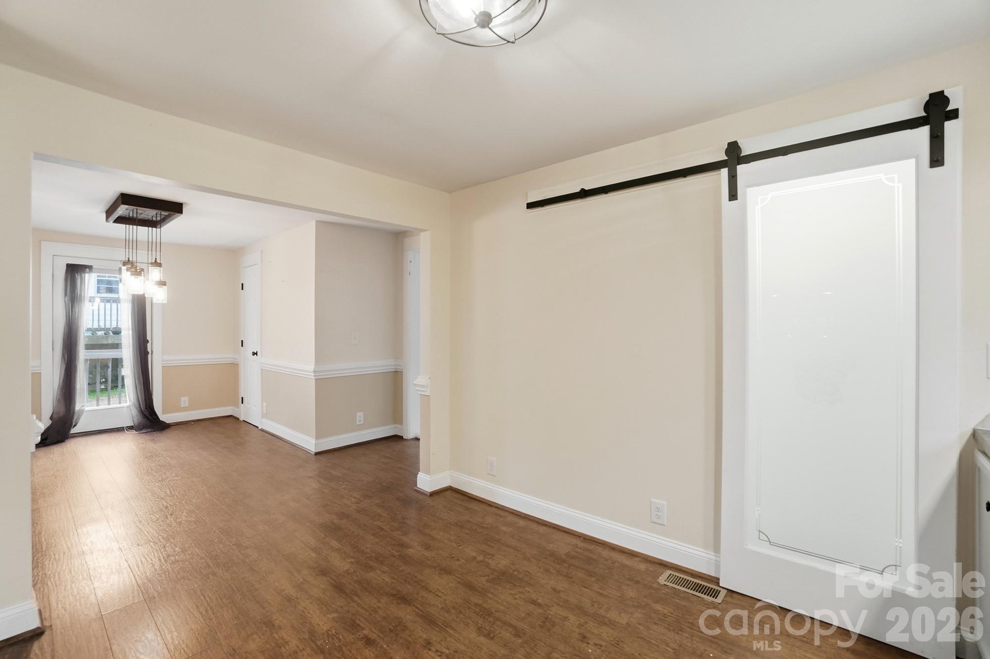 149 Swink Street Southwest Concord, NC 28027 - Photo 15 of 24 a view of an empty room with wooden floor and a window
