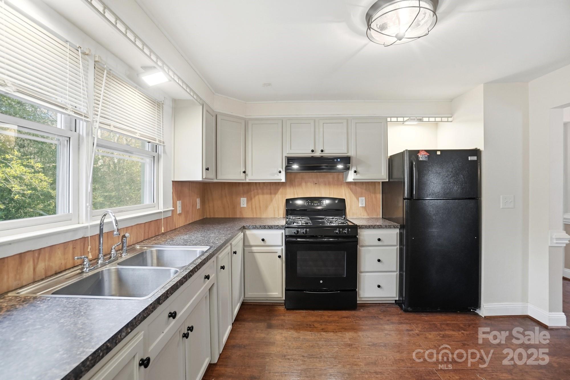 149 Swink Street Southwest Concord, NC 28027 - Photo 16 of 27 a kitchen with stainless steel appliances granite countertop a sink stove and refrigerator
