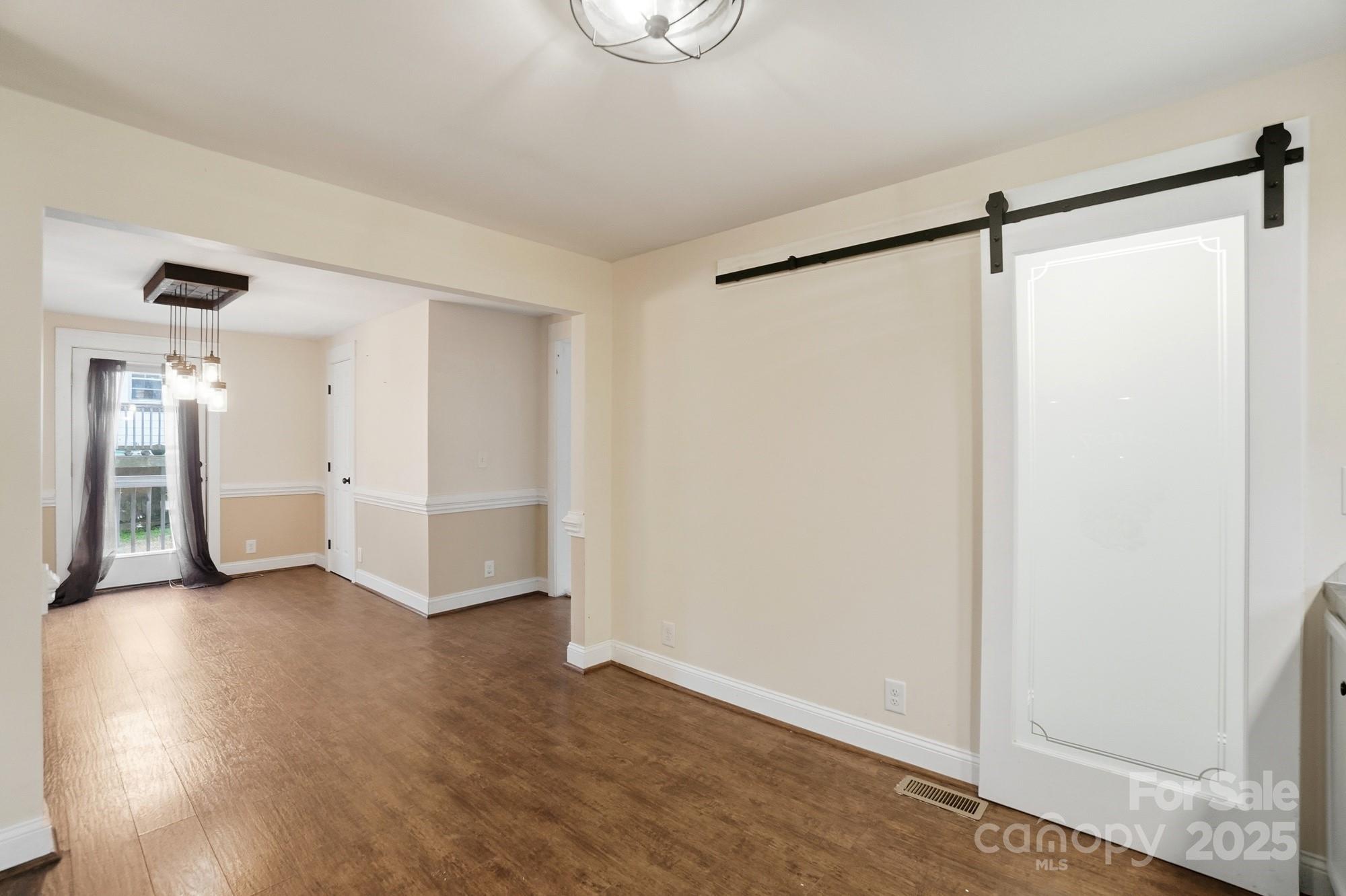 149 Swink Street Southwest Concord, NC 28027 - Photo 17 of 27 a view of an empty room with wooden floor and a window