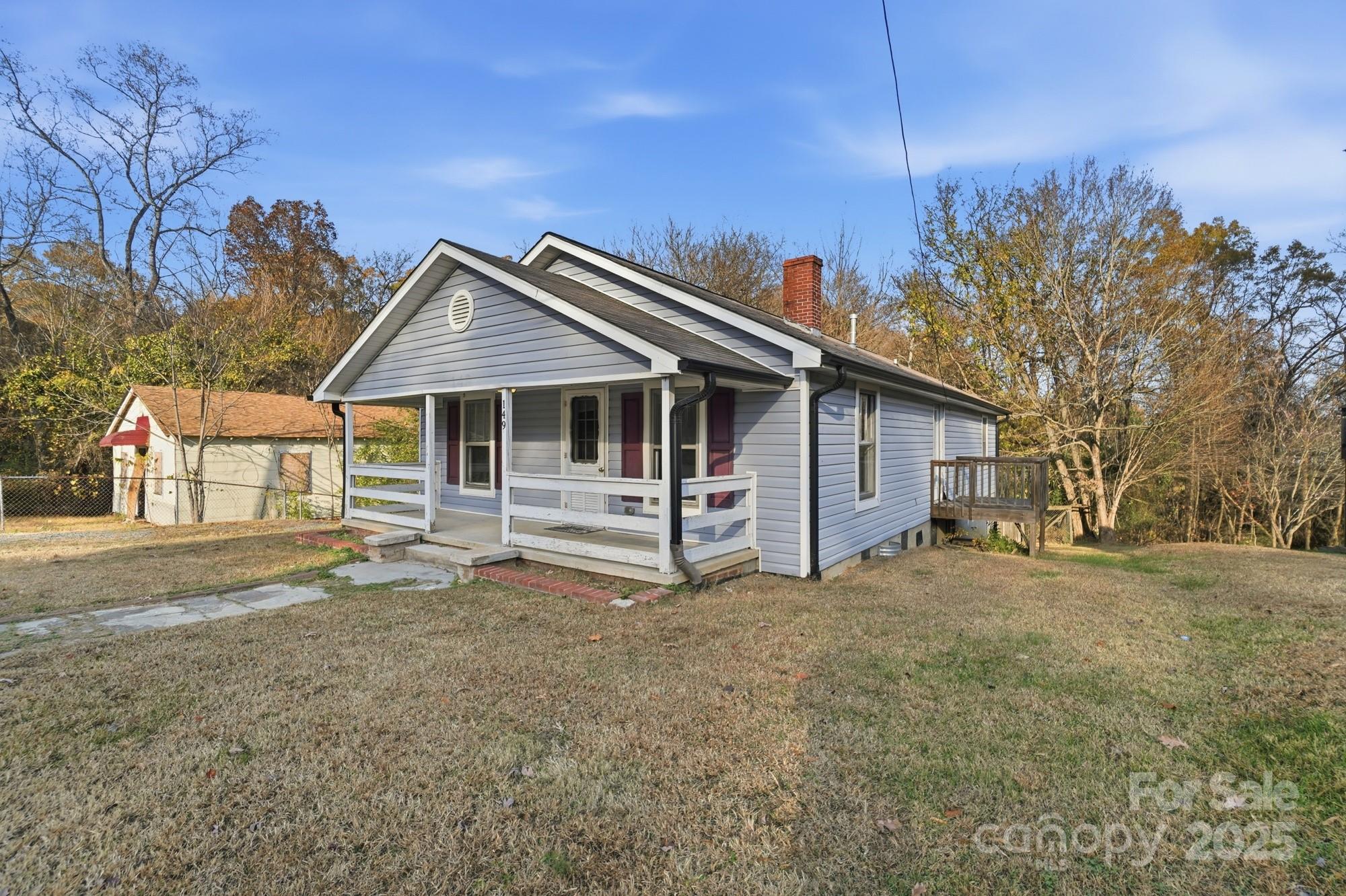 149 Swink Street Southwest Concord, NC 28027 - Photo 3 of 27 a house with trees in the background