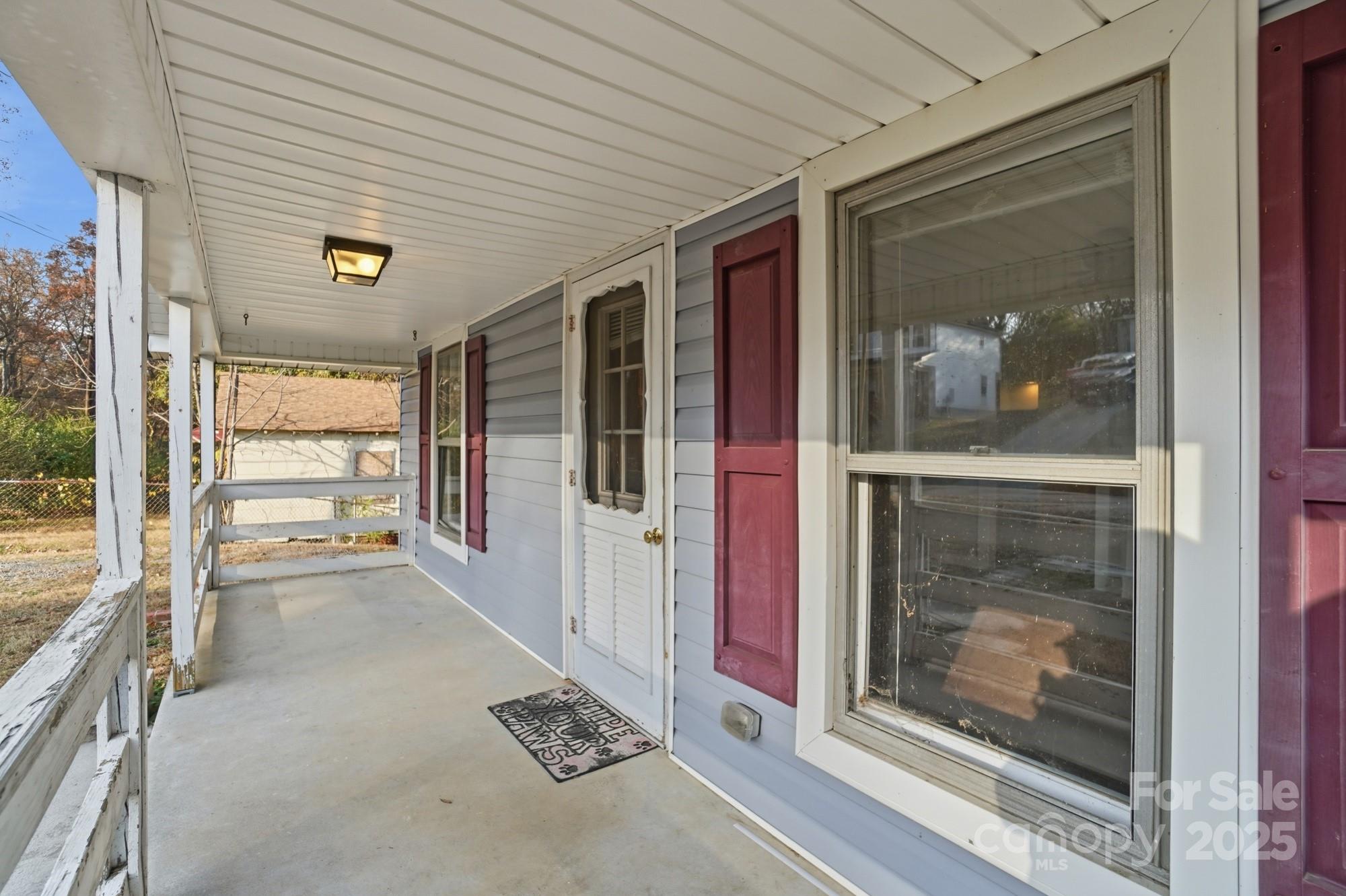 149 Swink Street Southwest Concord, NC 28027 - Photo 5 of 27 a view of a hallway with wooden floor and a fireplace