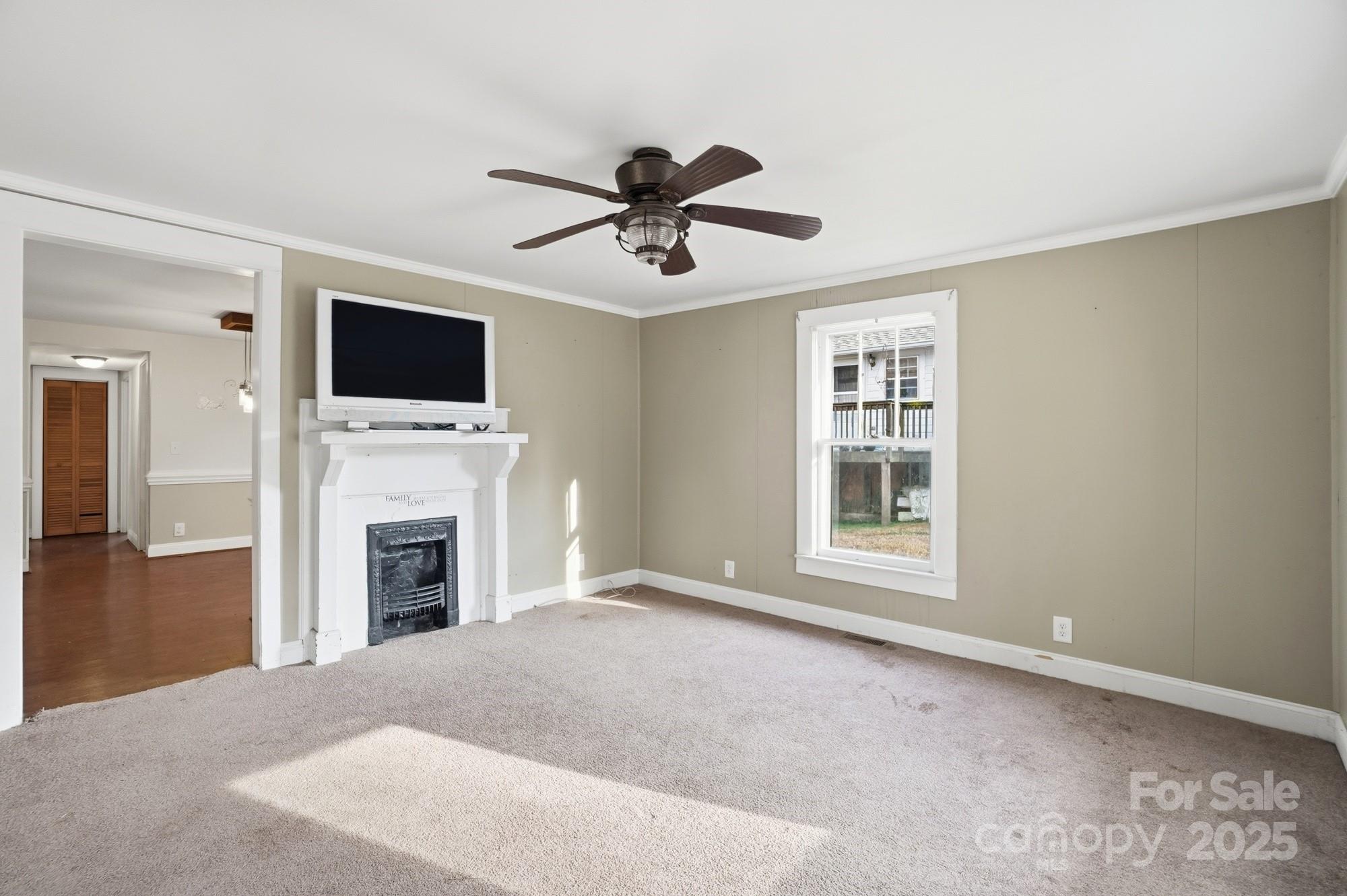 149 Swink Street Southwest Concord, NC 28027 - Photo 8 of 27 a living room with furniture a fireplace and a flat screen tv
