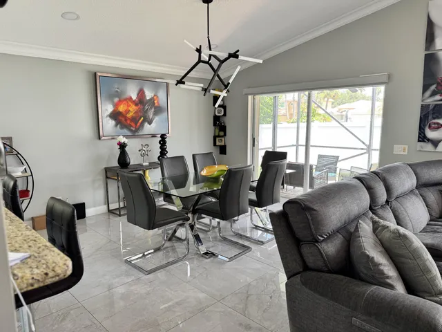 a living room with furniture a couch and a chandelier