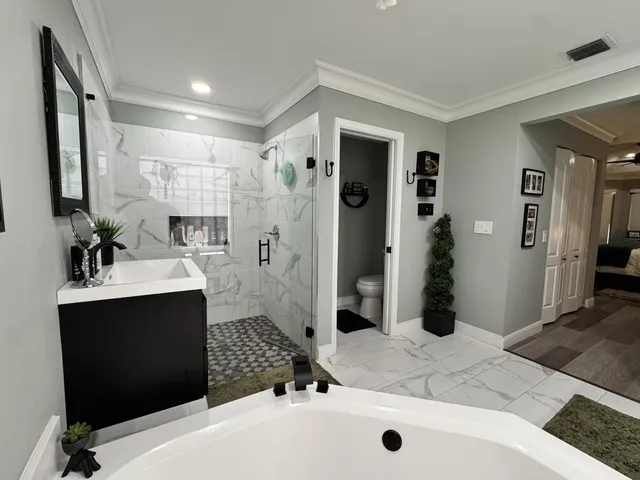a spacious bathroom with a double sink shower and mirror