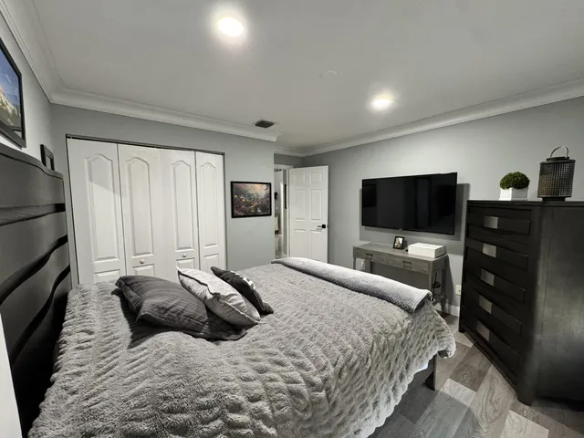 a bedroom with a bed and a flat screen tv