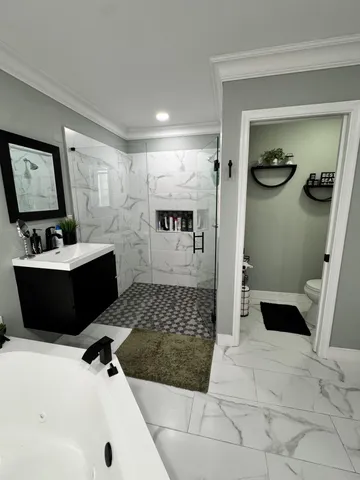 a bathroom with a sink a toilet and shower